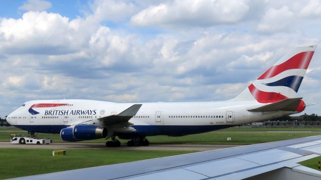 Boeing 747-400 (G-CIVO) - BA G-CIVO being towed to a gate at Heathrow Terminal 5 on June 28, 2016.  Taken from BA1483, A320-232, G-EUUL, seat 21F. 