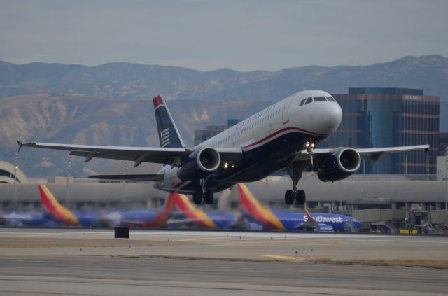 Airbus A320 (N651AW) - N651AW just lifting off of runway 20R for its early morning flight the Phoenix.