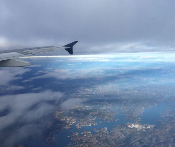 Airbus A319 — - Flying into some ominous clouds!