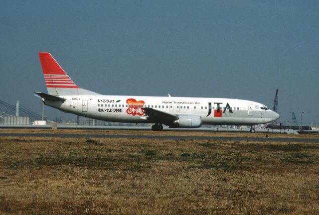 BOEING 737-400 (JA8597) - Taxing at Tokyo-Haneda Intl Airport on 2002/02/23 " Ikouyo! Oideyo! Okinawa Logo "
