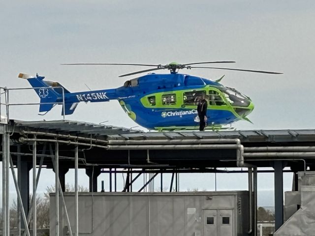 KAWASAKI EC-145 (N145NK) - BEEBE HEALTHCARE HELIPAD-LEWES, DELAWARE, USA-MARCH 20, 2025: A medevac helicopter pilot is seen by RF at approximately 1152 hrs. making a last minute check before taking off from the rooftop helipad of Beebe Healthcare, located on Savannah Road in Lewes, Delaware.