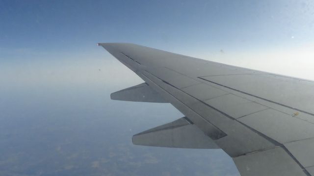 BOEING 737-600 — - Flying over Lake Ontario before we connect in Toronto to Calgary. Small clouds low on the surface.