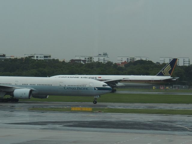 BOEING 777-300 (9V-SWY) - Taxiing Singapore 777 passing Cathay 777.