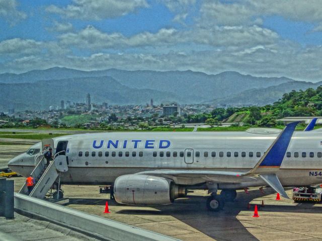 Boeing 737-700 — - A United Boeing 737-700 rests at one of the few gates at the dangerous and terrestrial Toncontin International Airport, in Tegucigalpa, Honduras.