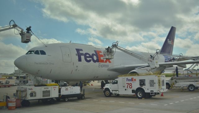 — — - FedEx plane having a afternoon wash.
