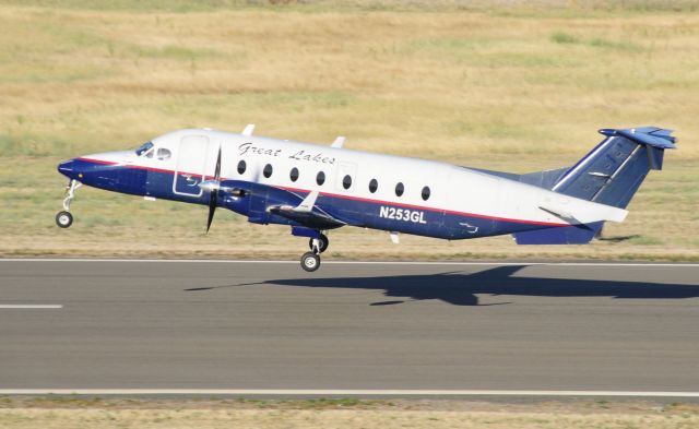 Beechcraft 1900 (N253GL) - Great Lakes Aviation Flight #321 departs Merced Regional Airport via runway one-two on its one hour flight to  McCarran Intl (KLAS)