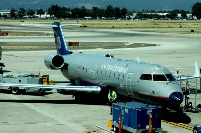 Canadair Challenger (N953SW) - Preparing for departure, Gate 11 (06/26/2010)  **Tint in picture is from windows in Gate area.