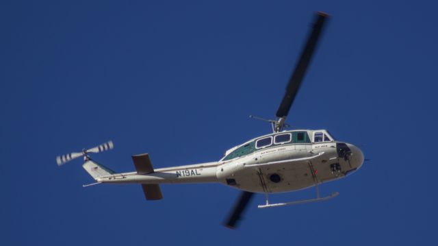 Bell UH-1V Iroquois (N19AL) - Bell 205B chase helicopter flying over my house in Amarillo, Texas.