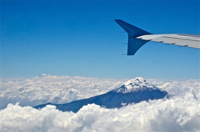 Airbus A320 — - Over volcano Popocatépetl (in the background to the left Volcán de Colima) heading to Oaxaca, México