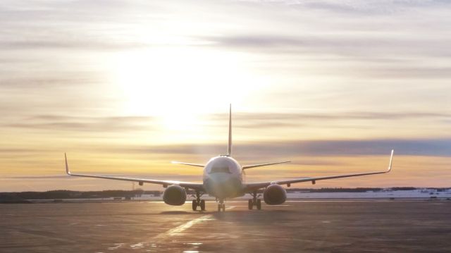 Boeing 737-700 — - Waiting to depart at sunset.