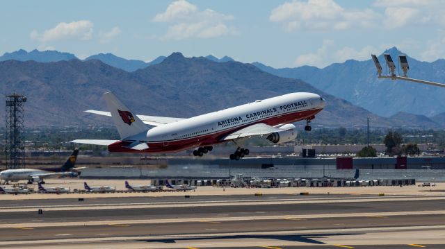 Boeing 777-200 (N867DA) - Arizona Cardinals 777-200 taking off from PHX on 8/28/22. Taken with a Canon 850D and Rokinon 135mm f/2 manual focus lens.