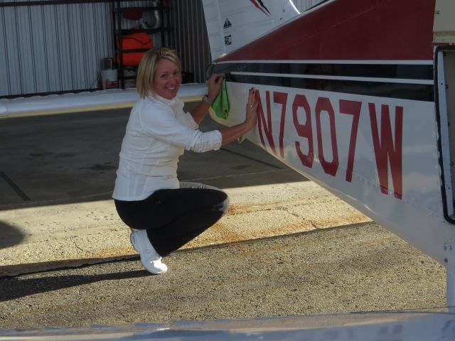 Piper Cherokee (N7907W) - My co-pilot - Coryee Hamons, putting a little wax on our 1965 Cherokee after flying around the mountains all weekend.