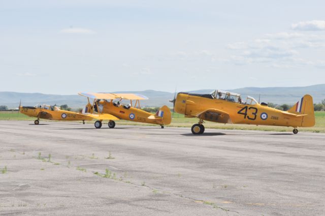 — — - Harvard Mk. IV (CF-ROA). Stearman (Boeing) PT-27 Kaydet C-GKUE, Fairchild Cornell Mk. II CF-YQR taxiing for take off