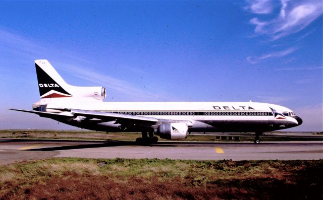 Lockheed L-1011 TriStar (N712DA) - KSFO - Delta L-1011 holding for 1R for Atlanta. There was a dirt parking lot here and one could park here for hours and get later PM photos. This color slide was taken date apprx mid June mid 1980s to 90. there is no slide date stamp on many of my slides. Minolta XD11