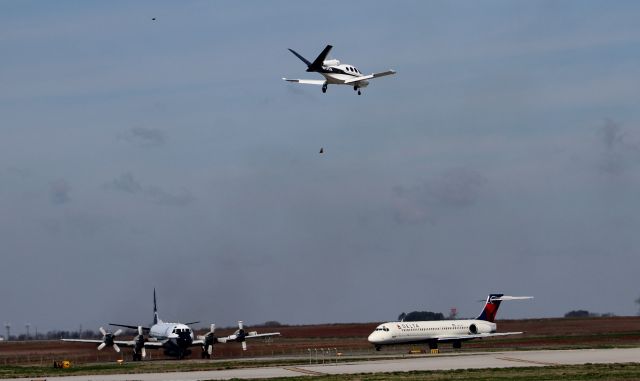 Cirrus Vision SF50 (N17CX) - A Cirrus Vision SF50 approaching touchdown on Runway 36R at Carl T. Jones Field, Huntsville International Airport, AL, with a Lockheed WP-3D Orion and a Boeing 717-200 on the taxiway awaiting their turn to go.