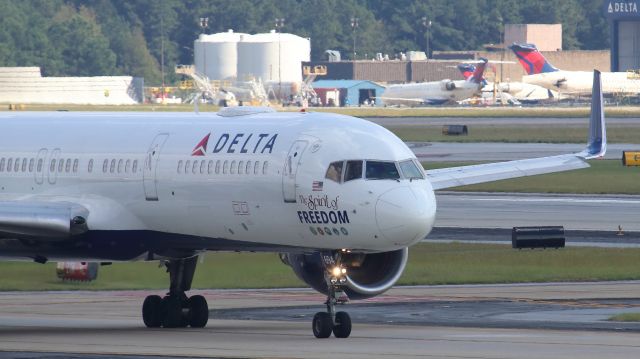 Boeing 757-200 (N694DL) - October 6, 2018 -- Delta 2111 taxis out to runway 9L for departure to Tampa, as Delta 82 (N803NW), an Airbus A332, is departing 9L for Paris, France.