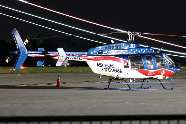 Bell 407 (N485AE) - SR22 lights are in the background. Photo taken on 9/10/2021.