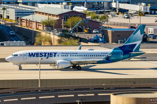 Boeing 737 MAX 8 (C-FXWJ) - A WestJet 737 MAX 8 taxiing at PHX on 2/9/23 during the Super Bowl rush. Taken with a Canon R7 and Tamron 70-200 G2 lens.