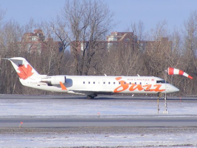 Canadair Regional Jet CRJ-200 (C-FVKN) - waiting in line for take off by wind flag.