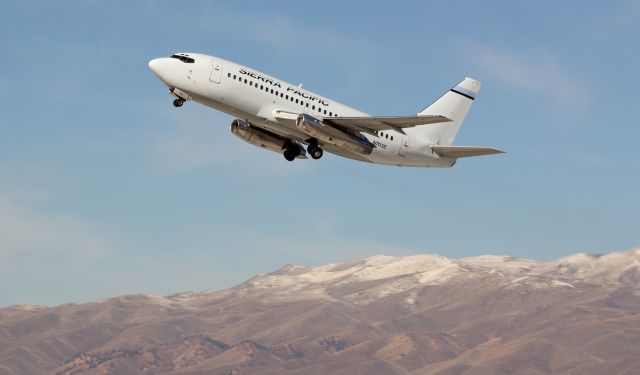 Boeing 737-200 (N703S) - Tucking the wheels in the wells after taking off from Reno Tahoe International, this Sierra Pacific B732 (N703S), one-half of SPAs two aircraft fleet, rockets skyward with the Sierra Nevada range in the background.  Note those two awesome old P&W JT8s with the clamshell reversers.  I absolutely love it when one of Sierra Pacs two B732s makes a visit here.  Catching them landing is always a treat (Ive just posted another shot of this one landing only a few feet away with those cool clamshell thrust reversers deployed), but the REAL thrill is when they takeoff as seen here. The unique whine as it accelerates on its "D" roll and the fighter-jet style crackle of those Pratts at full thrust as it blazes by and away is pure music in the air.