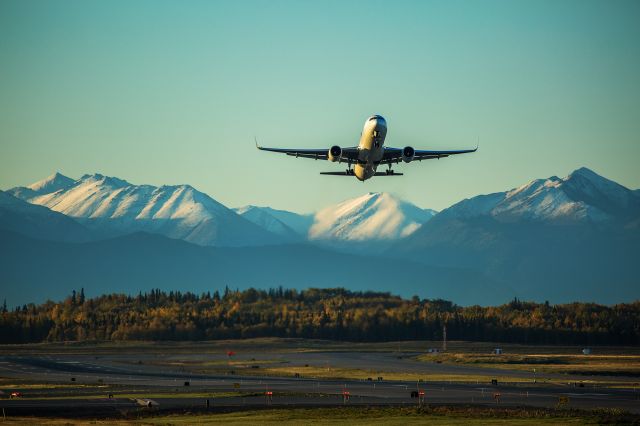 Boeing 737-700 — - Sunrise departure in Anchorage. Looking South from Pt. Woronzof