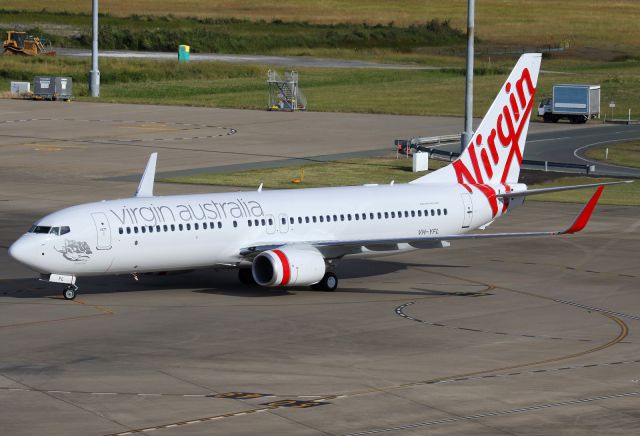 Boeing 737-700 (VH-YFL) - On delivery to Brisbane, arriving at the gate.