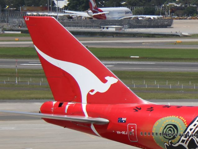 Boeing 747-400 (VH-OEJ) - Closeup of vertical fin, with a Qantas A380 in the background.