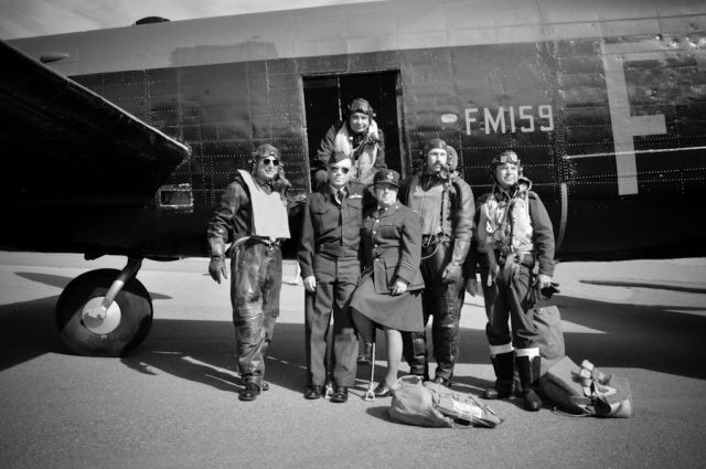 Avro 683 Lancaster (BXFM159) - WW II re-enactors pose at the crew door of FM-159.