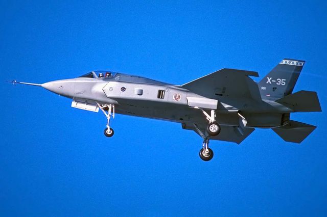 Canadair Regional Jet CRJ-700 (301) - Air Force Lockheed X-35A 301 Joint Strike Fighter prototype on approach to land at Air Force Plant 42 in Palmdale, California on November 22, 2000. It has a little black skunk on its tail. The blue tail stripe with white "x"s indicates that it is operated by the 412th Test Wing at Edwards Air Force Base.