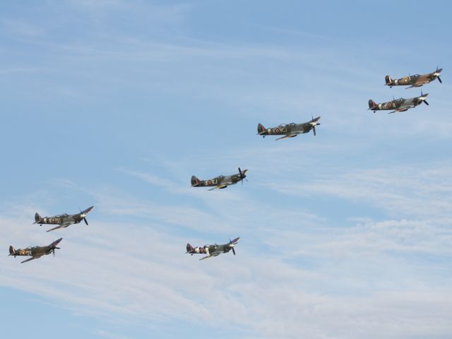— — - Supermarine Spitfire flypast at Duxford Air Museum.