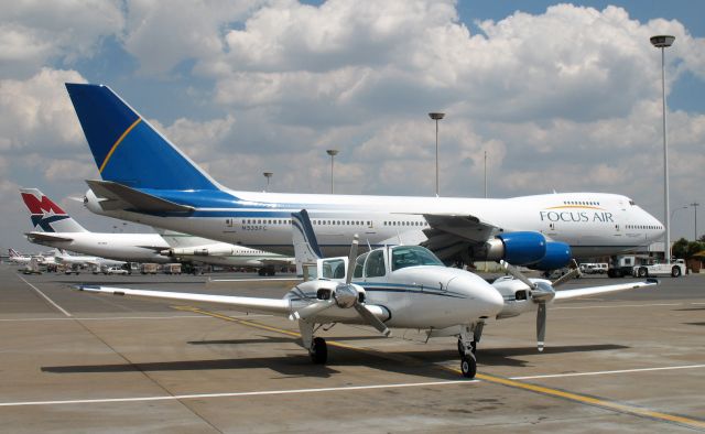 Beechcraft Baron (58) (ZS-MDJ) - Parked at the GA terminal in Johannesburg International airport, South Africa. Aircraft belongs to Progress Air.