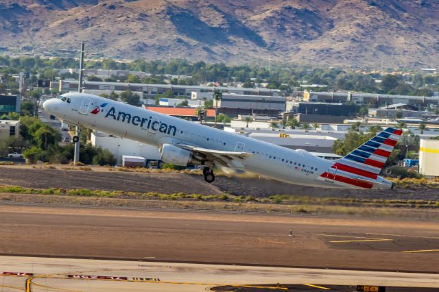 Airbus A321 (N154UW) - American Airlines A321 taking off from PHX on 9/28/22. Taken with a Canon 850D and Rokinon 135mm f/2 manual focus lens.