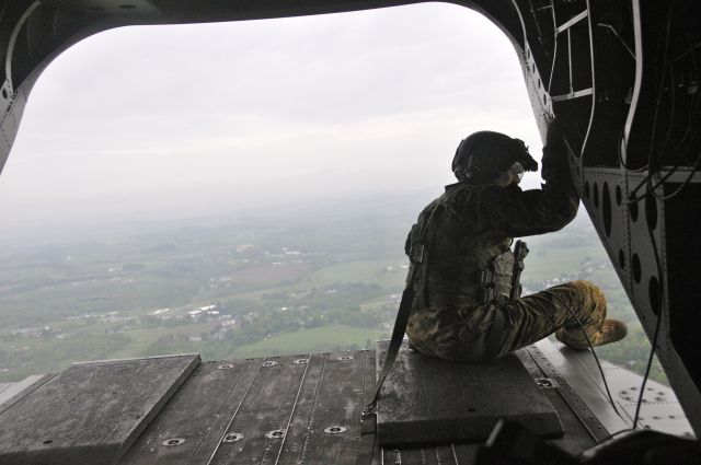 Boeing CH-47 Chinook — - A soldier Bravo Company, 2-104th General Support Aviation Battalion, 28th Combat Aviation Brigade looks out the back of a CH-47 Chinook helicopter as it flies over Dauphin County, PA, May 21, 2016.