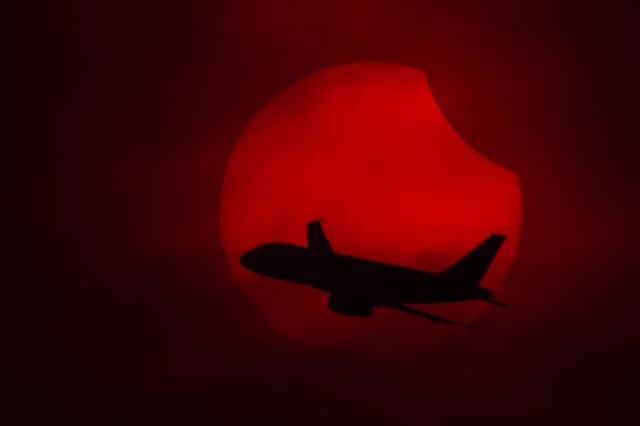 Airbus A319 (N504VL) - I was taking photos of last year partial solar eclipse (oct 23). From my vantage position, the sun was in a trajectory that would intercept the final turn to MEX final approach to 05 rwy.  Luck and opportunity coincided that day.