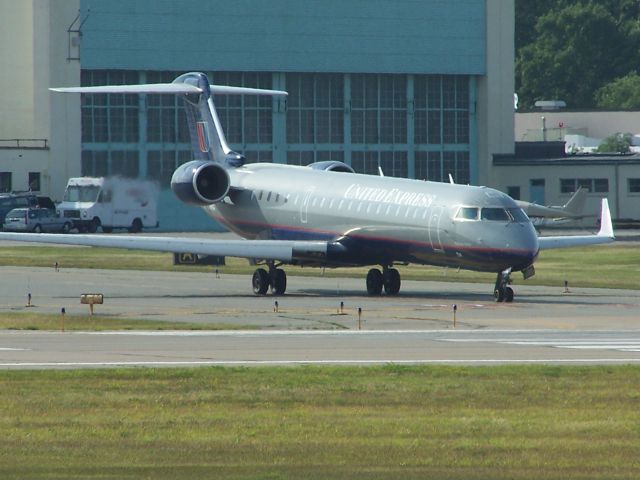 Canadair Regional Jet CRJ-700 (N514MJ) - N514MJ still in the dull United scheme waits for the runway at TF Green Airport Providence RI June 16th 2011