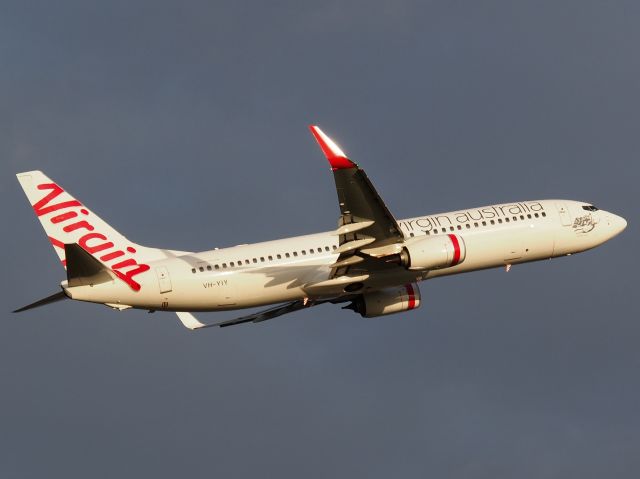 Boeing 737-700 (VH-YIY) - Lifting off on a dull, grey afternoon from runway 23 into the sunset at Adelaide International Airport. Photo taken from the Tapleys Hill Road viewing area.