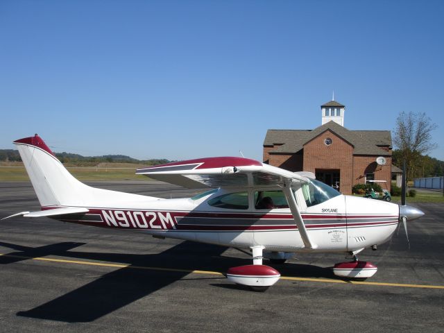 Cessna Skylane (N9102M) - This 1976 C182 is parked in front of the fueling station at Athens, TN (KMMI)with the FBO in the background.  A 280hp Texas Skyways carbuerated continental IO 520 gives this baby awesome T/O, climb and cruises at 150kts on 15gph.