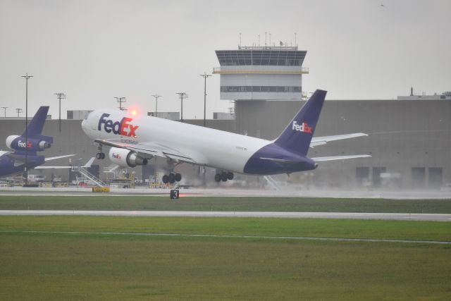 BOEING 767-300 (N180FE) - Parking garage roof. 08-01-20 in the rain.