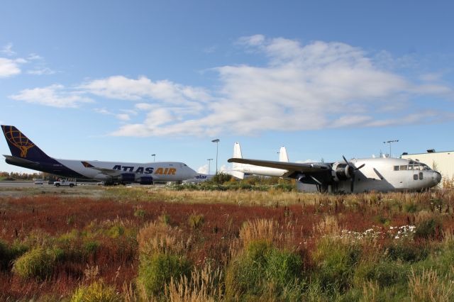 N9027K — - Fairchild C-119 Flying Boxcar sits sadly in an overgrown section of the Anchorage, AK International Airport watching the 747s come and go from many different parts of the world.