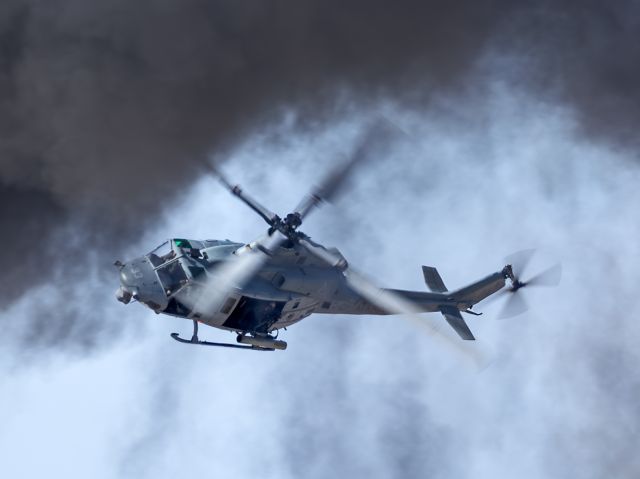 BELL UH-1Y (16-9247) - A UH-1Y Venom from Marine Operational Test and Evaluation Squadron One (VMX-1) turning back through the smoke for another pass during the Marine Air Ground Task Force (MAGTF) demo with pyro at the Yuma Air Show, 9 Mar 2024.