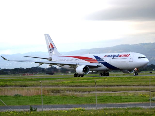 Airbus A330-300 (9M-MTC) - On taxi-way heading for take off on runway 05, for flight home to Kuala Lumpur, just before the arrival of a rain storm. Thursday 12th July 2012.