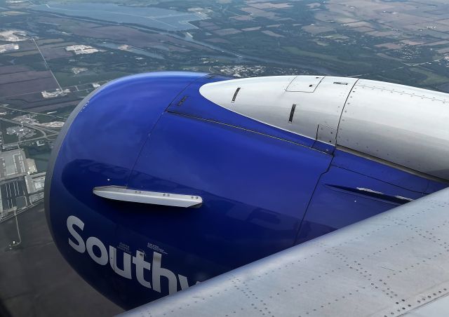 Boeing 737-700 (N229WN) - 5/31/22  lighting conditions were perfect to reflect the forward fuselage in the starboard cowling. Descending over western Chicago for MDW flight 2135