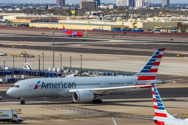 Boeing 787-8 (N802AN) - An American Airlines 787-8 taxiing while Southwest Tennessee One lands at PHX on 2/11/23 during the Super Bowl rush. Taken with a Canon R7 and Canon EF 100-400 II L lens.