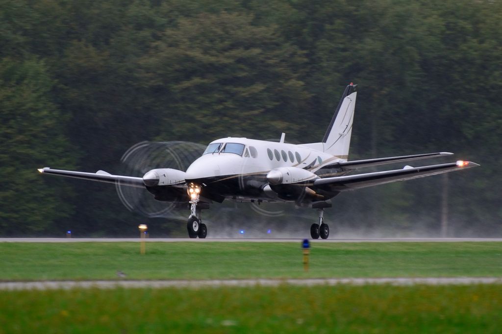 Beechcraft King Air 100 — - Departing runway 8 during a soaking rain shower