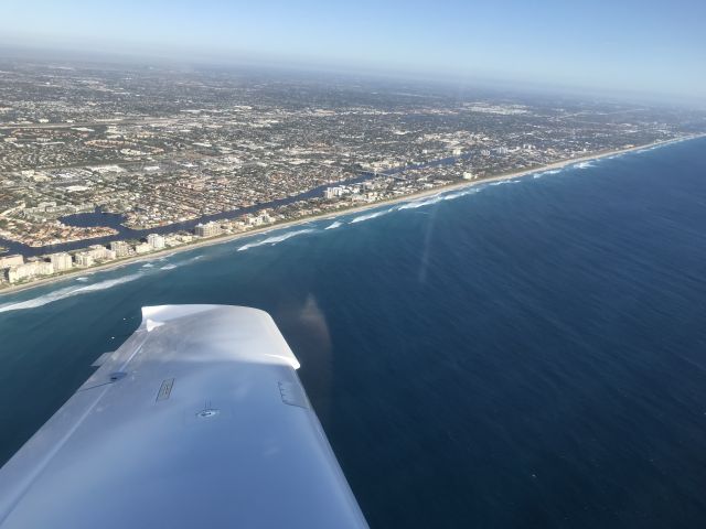 Cessna 350 (N1443T) - Departing Boca Raton