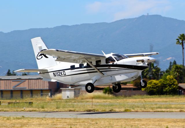 Quest Kodiak (N112KQ) - Rare visitor departing with the infamous Mt Umunhum in the background. Note the square "box" on top of the Mountian. Its an abandoned radar facility that was used back in the Cold War to protect the California coast from incoming ships/planes/etc.