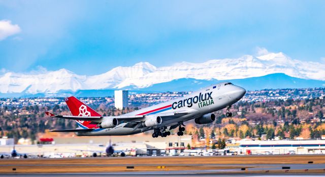 Boeing 747-400 (LX-VCV) - Went up to the parking garage to see the departure to Luxembourg with a beautiful mountain scene.