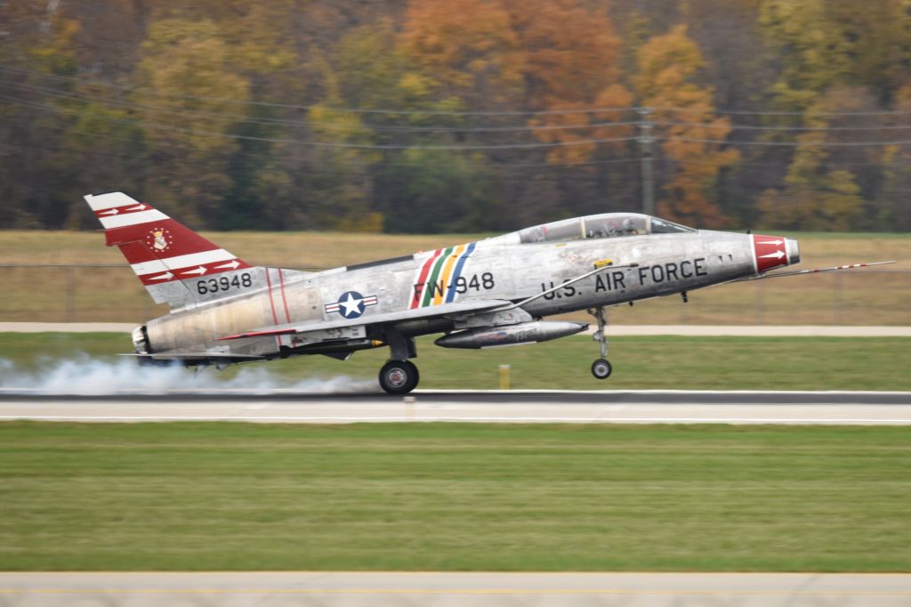 North American Super Sabre (N2011V) - Squeking the wheels and smoking the tires. 5-L 10-28-23 returning after its airshow performance at nearby MQJ. Was treated to two low level high speed passes before this full stop landing. What a thrill to see one of these ancient relics flying. 67 years old!
