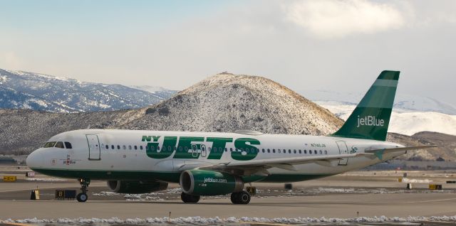 Airbus A320 (N746JB) - JBUs N746JB, wearing the NFLs "NY Jets" "uniform," turns from Alpha taxiway toward runway 16R in this shot taken at 2 PM yesterday afternoon (6 Mar 2017).  Rattlesnake Mountain is in the background.  