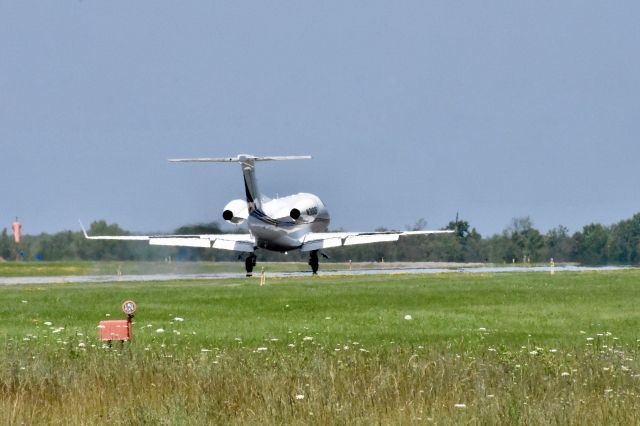 Embraer Phenom 300 (N310QS) - NetJets Business Jet touching down on Runway 2.